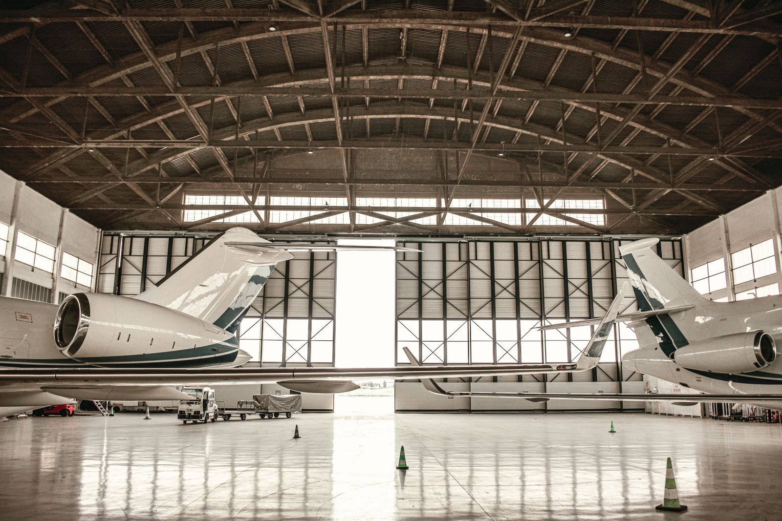 Two private jets inside a hangar