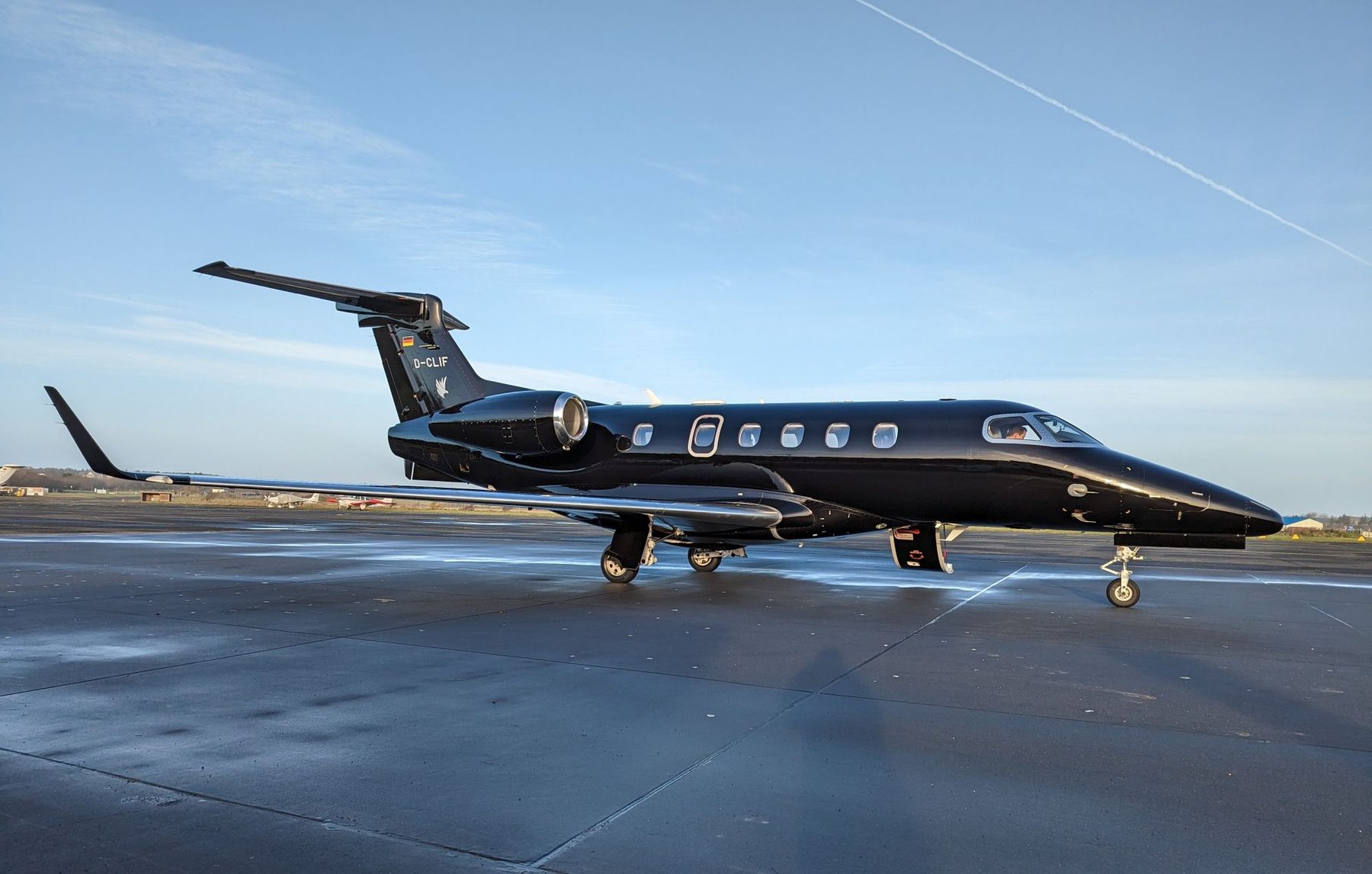 A sleek private jet on the ramp